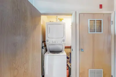 a television sitting on top of a refrigerator in a room at At the Crossroads in Frisco