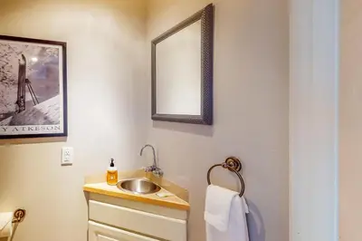a bathroom with a sink and a mirror at At the Crossroads in Frisco