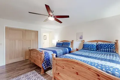 two beds in a bedroom with a ceiling fan at Lakeside Mountain Retreat in Dillon