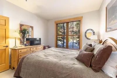 a bedroom with a bed and a tv and a window at 8758 Trappers Crossing condo in Dillon