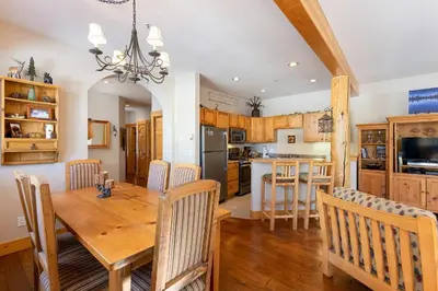 a kitchen and dining room with a wooden table and chairs at 8758 Trappers Crossing condo in Dillon