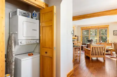 a kitchen with a refrigerator and a dining room at 8758 Trappers Crossing condo in Dillon