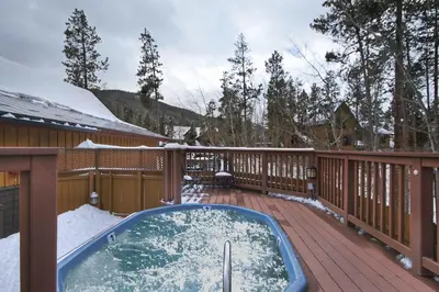 a hot tub on a deck in the snow at 8758 Trappers Crossing condo in Dillon