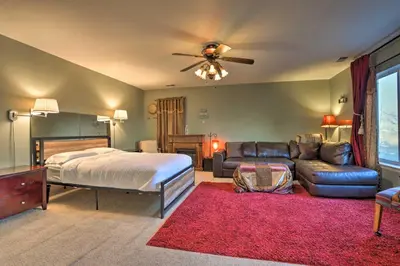 a bedroom with a bed and a couch at Green Valley Ranch - Family Home 13 Mins to DIA in Denver