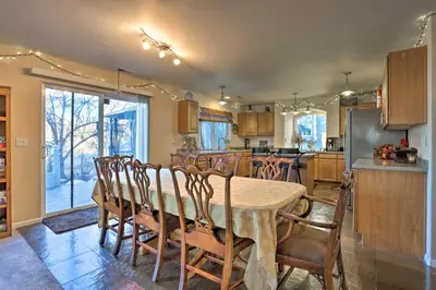 a kitchen with a table and chairs and a refrigerator at Green Valley Ranch - Family Home 13 Mins to DIA in Denver