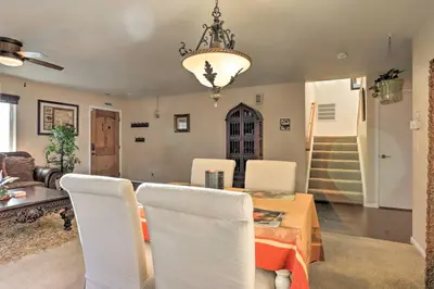 a dining room with a table and chairs and a chandelier at Green Valley Ranch - Family Home 13 Mins to DIA in Denver