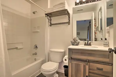 a white bathroom with a toilet and a sink at Green Valley Ranch - Family Home 13 Mins to DIA in Denver