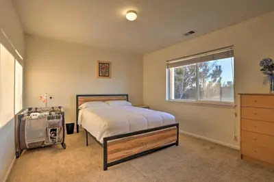 a bedroom with a large bed and a window at Green Valley Ranch - Family Home 13 Mins to DIA in Denver