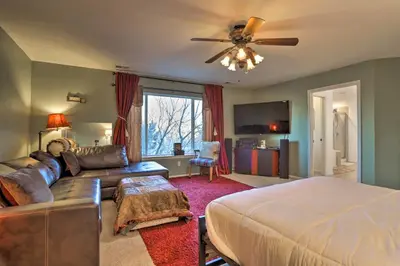 a living room with a bed and a couch at Green Valley Ranch - Family Home 13 Mins to DIA in Denver