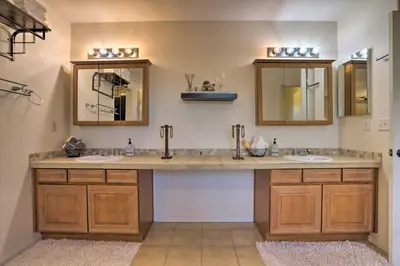 a bathroom with two sinks and two mirrors at Green Valley Ranch - Family Home 13 Mins to DIA in Denver