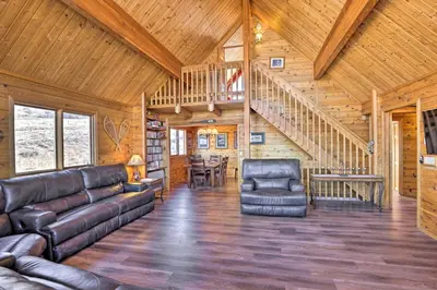 a living room with leather furniture and a wooden ceiling at 1 Mi to Granby Ranch Family-Friendly Cabin! in Granby
