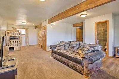 a living room with a couch and a television at 1 Mi to Granby Ranch Family-Friendly Cabin! in Granby