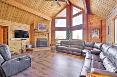 a living room with a leather couch and a fireplace at 1 Mi to Granby Ranch Family-Friendly Cabin! in Granby