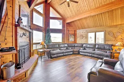 a living room with a leather couch and a tv at 1 Mi to Granby Ranch Family-Friendly Cabin! in Granby