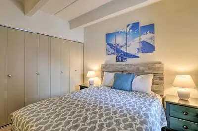 a bedroom with a bed and two paintings on the wall at 1 Mi to Dillon Reservoir Condo Retreat in Frisco! in Frisco