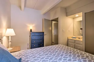 a bedroom with a bed and a bathroom with a sink at 1 Mi to Dillon Reservoir Condo Retreat in Frisco! in Frisco