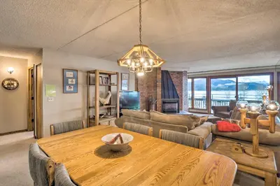 a living room with a wooden table and a couch at 7 Mi to Keystone Resort Condo with Hot Tub and Pool in Dillon