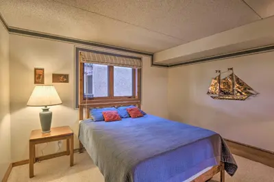 a bedroom with a bed and a lamp and a window at 7 Mi to Keystone Resort Condo with Hot Tub and Pool in Dillon
