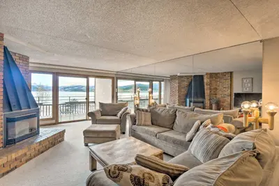 a living room with a couch and a tv at 7 Mi to Keystone Resort Condo with Hot Tub and Pool in Dillon