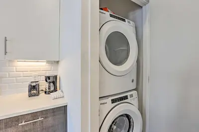 a washer and dryer in a small kitchen at Downtown Denver Studio Less Than 1 Mi to Coors Field! in Denver