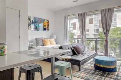 a living room with a couch and a table at Downtown Denver Studio Less Than 1 Mi to Coors Field! in Denver