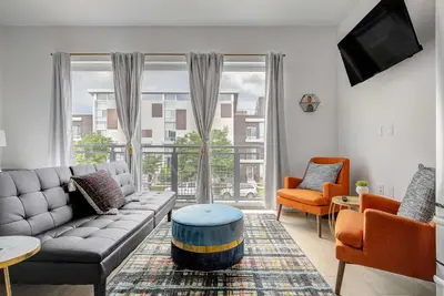 a living room with a couch and a large window at Downtown Denver Studio Less Than 1 Mi to Coors Field! in Denver