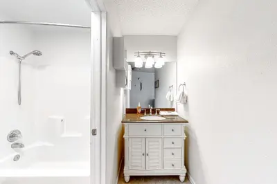 a white bathroom with a sink and a shower at Snowblaze Studio in Winter Park