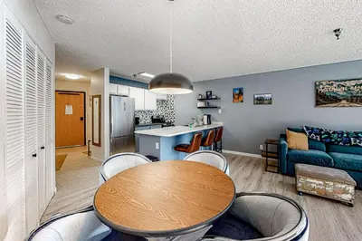a living room with a table and chairs and a couch at Snowblaze Studio in Winter Park