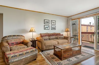 a living room with two couches and a table at Buffalo Woods 216 - Wildernest in Silverthorne