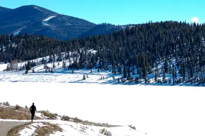 a person standing on top of a snow covered mountain at Buffalo Woods 216 - Wildernest in Silverthorne