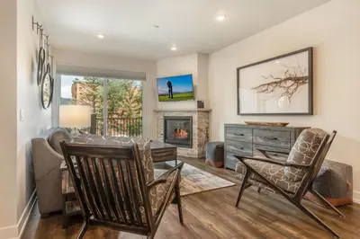 a living room with a table and chairs and a fireplace at Sail Lofts at Lake Dillon 1107 in Dillon
