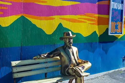 a statue of a man in a hat sitting on a bench at Sail Lofts at Lake Dillon 1107 in Dillon