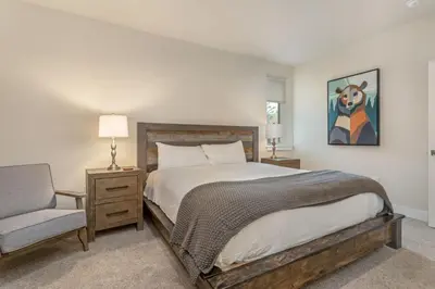 a bedroom with a large bed and a chair at Sail Lofts at Lake Dillon 1107 in Dillon