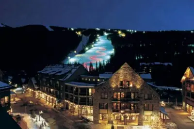 a town with a mountain in the background at night at Lake Ridge at Lake Dillon in Dillon