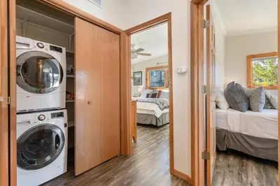 a laundry room with a washer and dryer and a bedroom at Lake Ridge at Lake Dillon in Dillon