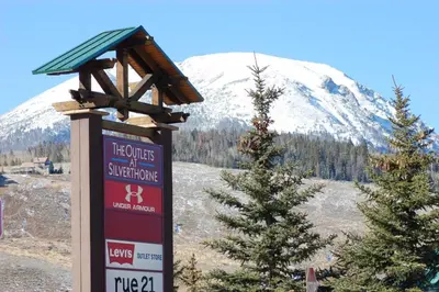 a sign in front of a snow covered mountain at Lake Ridge at Lake Dillon in Dillon