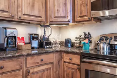 a kitchen with wooden cabinets and a counter top at Rolling Ridge 20C - Wildernest in Silverthorne