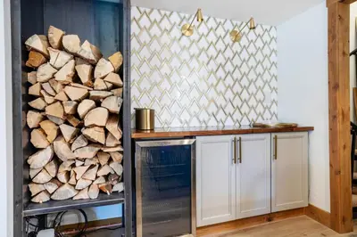 a kitchen with a stack of fire wood at Wild Irishman 1027 - Keystone in Keystone