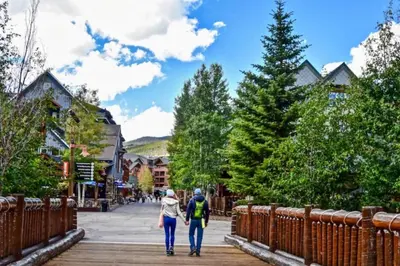 two people walking down a boardwalk in a town at Wild Irishman 1027 - Keystone in Keystone
