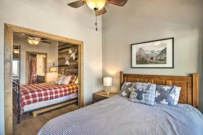 a bedroom with a bed and a mirror at Ski-InandSki-Out Granby Ranch Home Mountain Views! in Granby