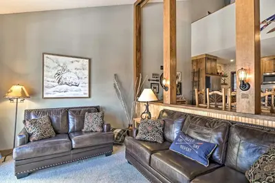 a living room with leather couches and a mirror at Ski-InandSki-Out Granby Ranch Home Mountain Views! in Granby