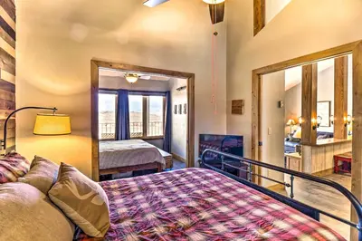 a bedroom with a bed and a view of a room at Ski-InandSki-Out Granby Ranch Home Mountain Views! in Granby