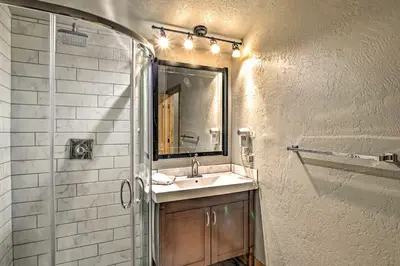 a bathroom with a sink and a shower and a mirror at Ski-InandSki-Out Granby Ranch Home Mountain Views! in Granby