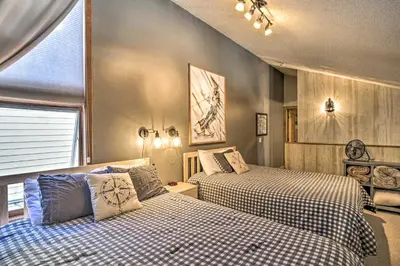 a bedroom with two beds and a window at Ski-InandSki-Out Granby Ranch Home Mountain Views! in Granby