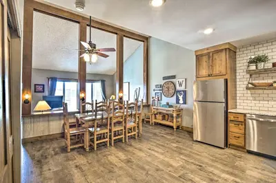 a kitchen and dining room with a table and a refrigerator at Ski-InandSki-Out Granby Ranch Home Mountain Views! in Granby