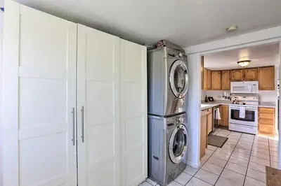 a kitchen with white cabinets and a washer and dryer at half Mi to Tennyson Pet-Friendly Denver Gem in Denver