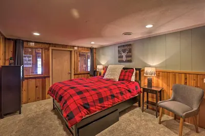 a bedroom with a bed and a chair at Wildmanor Ranch Near Red Rocks with Hot Tub! in Morrison