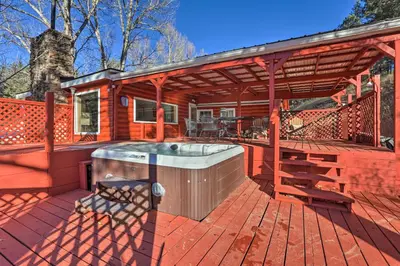 a hot tub on the deck of a house at Wildmanor Ranch Near Red Rocks with Hot Tub! in Morrison