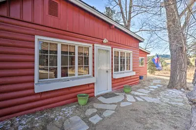 a red house with two windows and a door at Wildmanor Ranch Near Red Rocks with Hot Tub! in Morrison