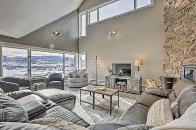 a living room with a couch and a tv at Stunning Condo in Fraser with Mountain Views! in Fraser